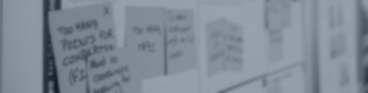 blurred sticky notes on a white board