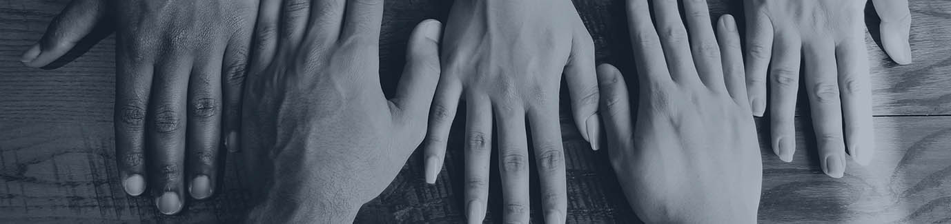 hands side by side on a desk